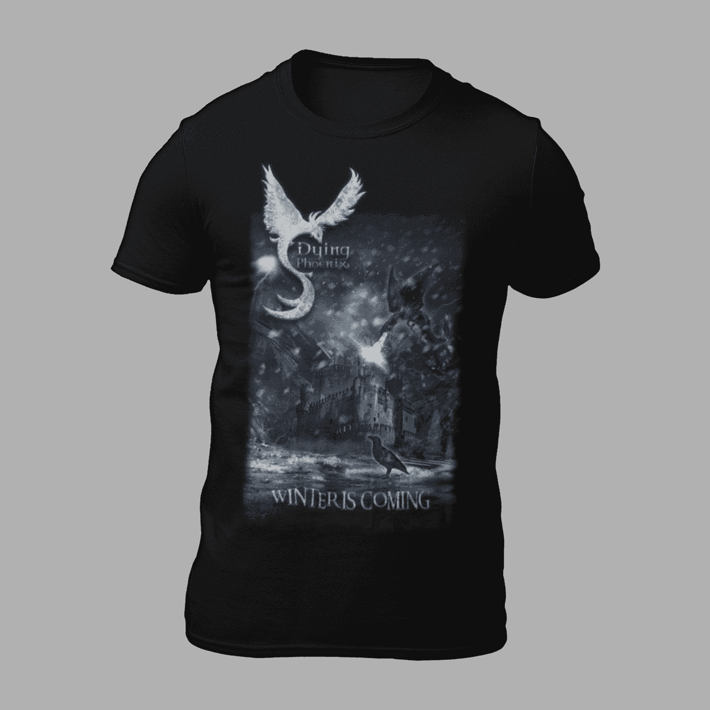 Dying Phoenix T-Shirt 'Winter Is Coming' features a fantasy phoenix over a dark castle scene with snow and ravens. Ideal for gothic and fantasy apparel fans.