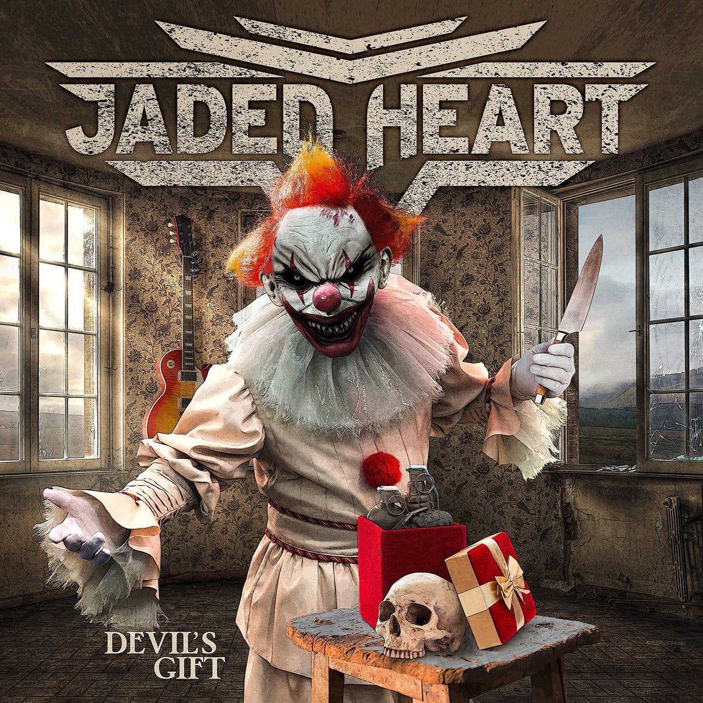 Close-up of Jaded Heart CD 'Devil's Gift' album cover showing an evil clown with a knife, skull, and red gift box in a decaying room.