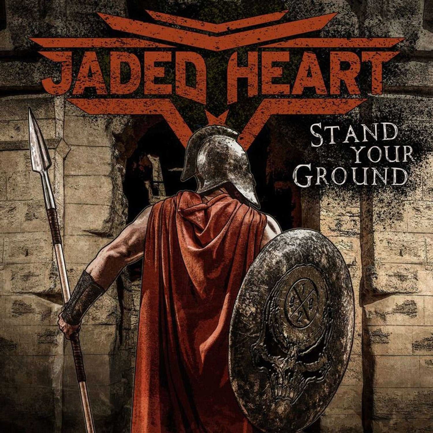 Close-up of Jaded Heart 'Stand Your Ground' CD cover showing a warrior in armor with shield and spear. Ideal for fans of hard rock music CDs.
