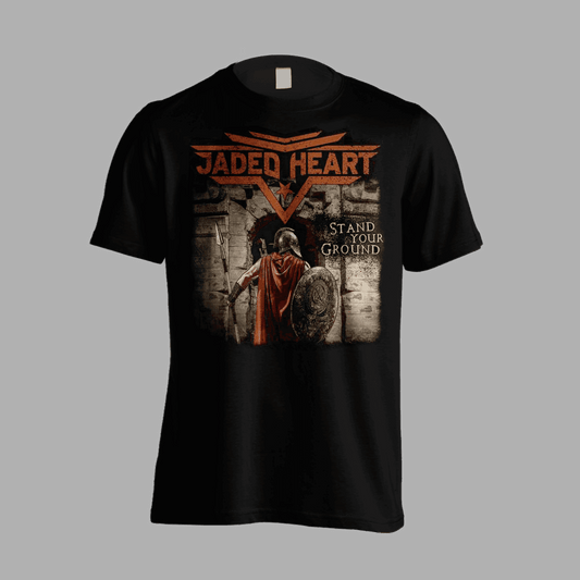 Jaded Heart T-Shirt 'Stand Your Ground' features a warrior with shield and spear at a stone gate, bold band logo and title on front. Ideal for rock fans.