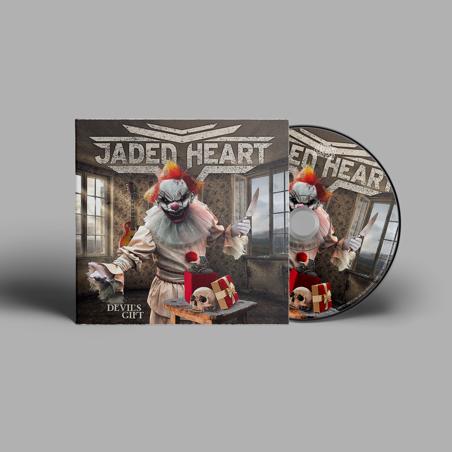 Jaded Heart CD 'Devil's Gift' digipack featuring a sinister clown with a knife, skull, and gift box in a dark room. Heavy metal music CD.